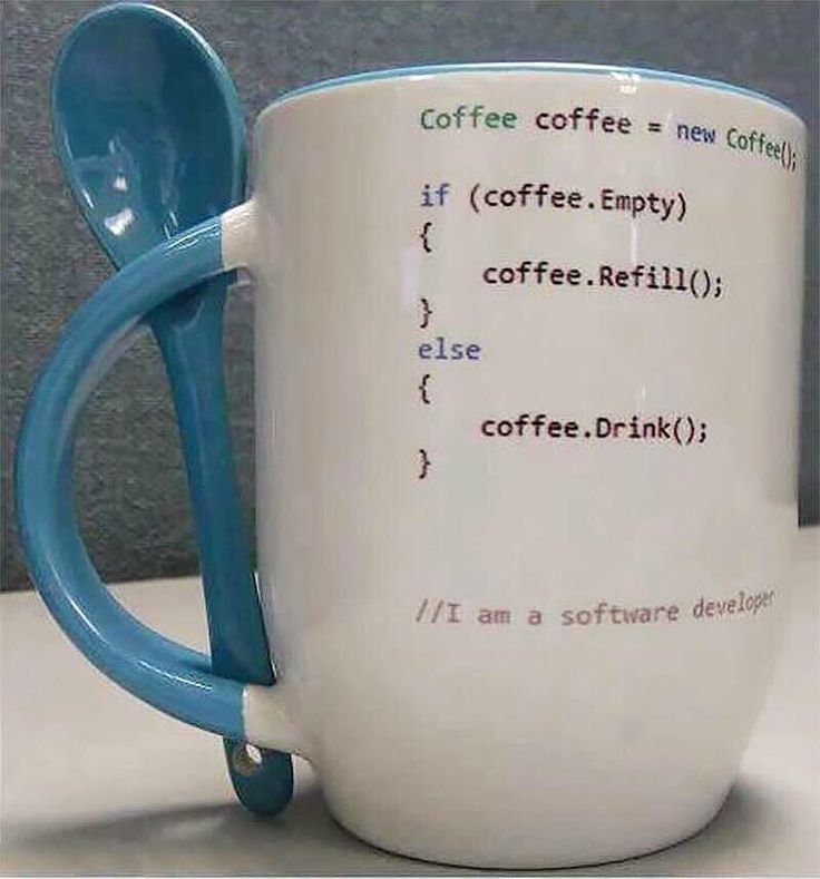 A white mug with pseudocode (perhaps Java?) on it;
its handle is blue, and there is a blue spoon slotted through holes in the top and bottom of the handle so that it is readily available for use